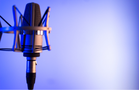 A microphone with a blue and white gradient at the back