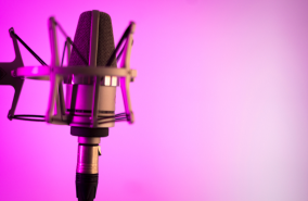A microphone with a pink and white gradient at the back